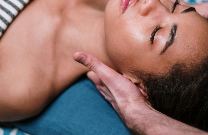 Woman lying on Bed - getting massaged